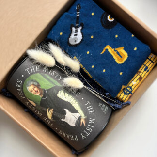 Na zdjęciu jest prezent "Nuty smakowe" z herbatą w muzycznej puszce i skarpetkami w muzyczne wzory